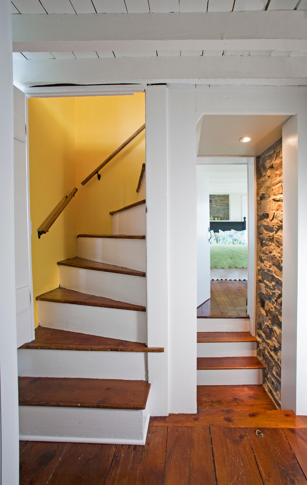 Design ideas for a mid-sized country wood spiral staircase in Philadelphia with painted wood risers.