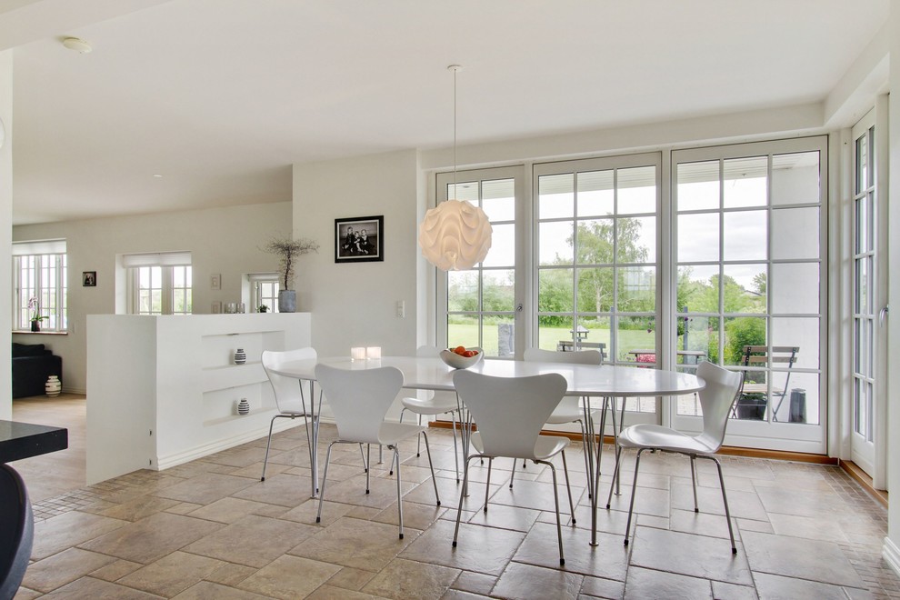 Inspiration for a mid-sized scandinavian dining room in Odense with white walls and travertine floors.