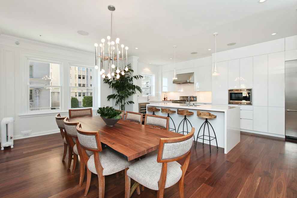 Photo of a transitional kitchen/dining combo in San Francisco with white walls and dark hardwood floors.