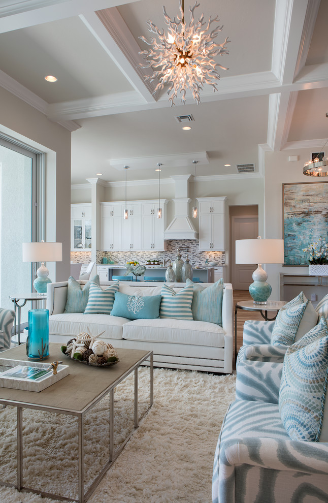 Inspiration for a mid-sized beach style open concept living room in Miami with beige walls and light hardwood floors.