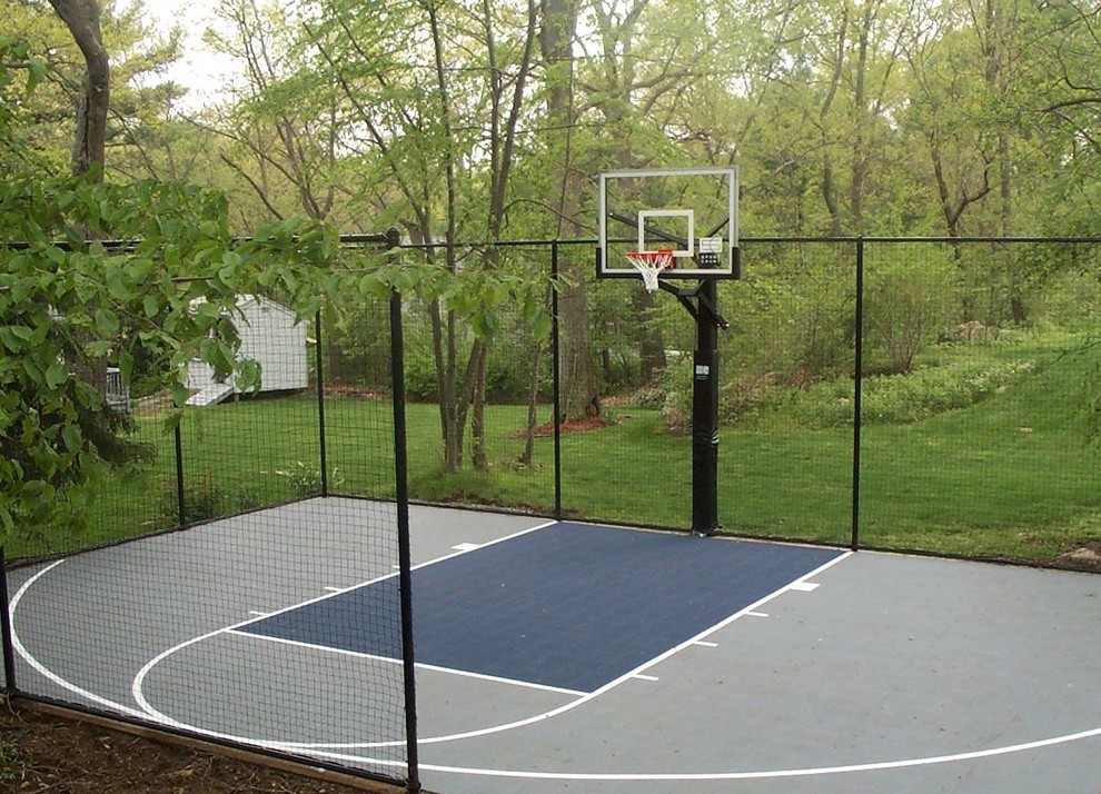This is an example of a small traditional backyard partial sun outdoor sport court in Boston with with outdoor playset and natural stone pavers.