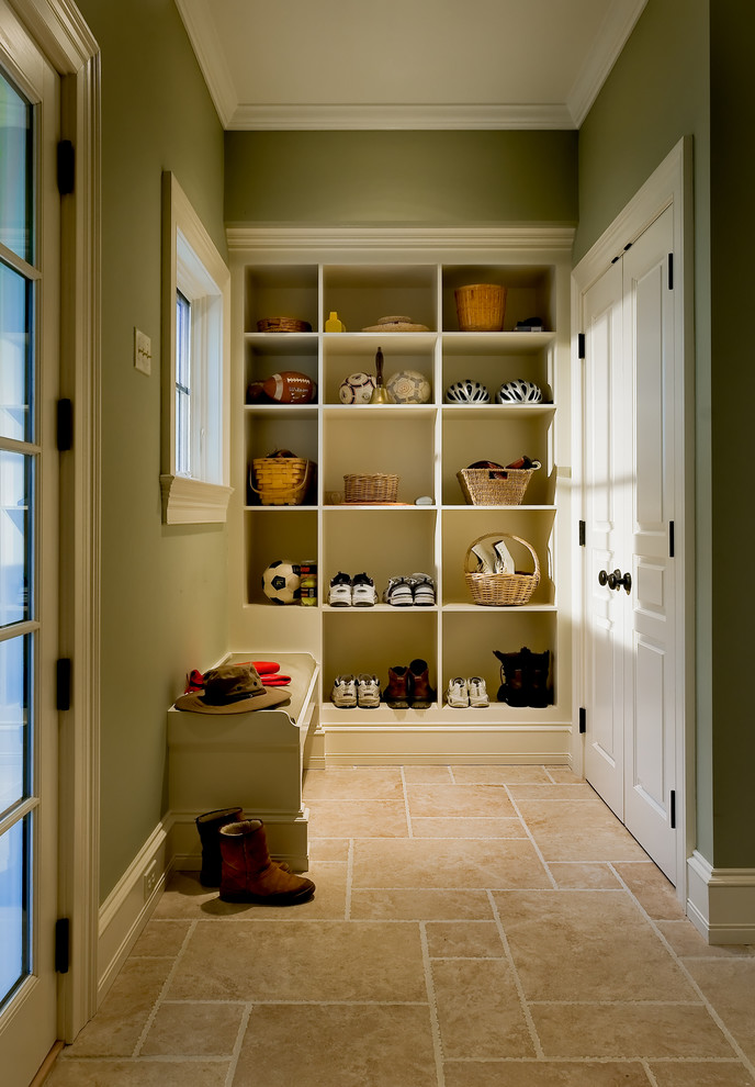 Photo of a traditional mudroom in New York with travertine floors and beige floor.