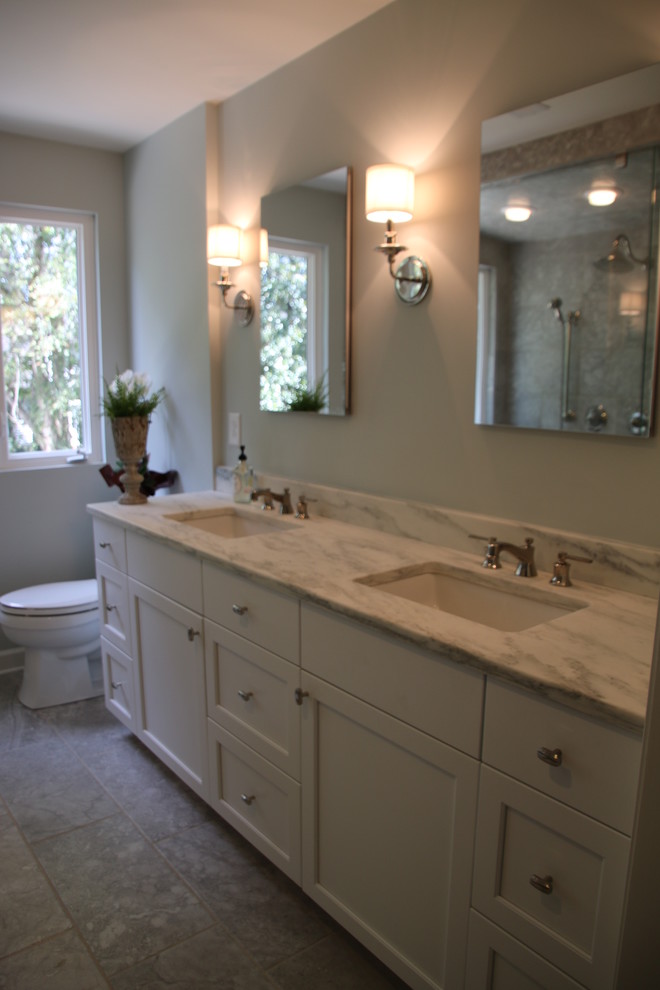 Mid-sized transitional master stone tile marble floor double shower photo in Charlotte with flat-panel cabinets, white cabinets, a two-piece toilet, an undermount sink and marble countertops