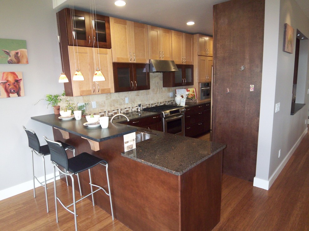 Inspiration for a mid-sized transitional galley bamboo floor eat-in kitchen remodel with an undermount sink, shaker cabinets, dark wood cabinets, quartz countertops, beige backsplash, ceramic backsplash, stainless steel appliances and a peninsula