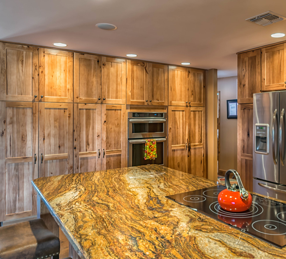 Open concept kitchen - large rustic u-shaped medium tone wood floor open concept kitchen idea in Phoenix with shaker cabinets, medium tone wood cabinets, granite countertops, stainless steel appliances and an island