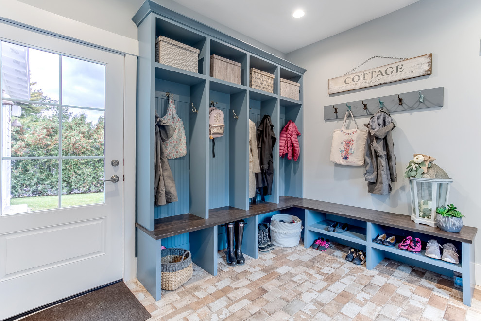 Large beach style mudroom in Other with grey walls, a single front door, a white front door and beige floor.
