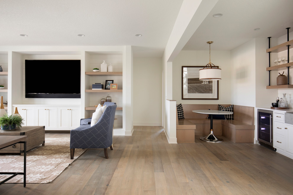 Inspiration for an expansive transitional open concept family room in Minneapolis with white walls, light hardwood floors, a built-in media wall, beige floor and planked wall panelling.