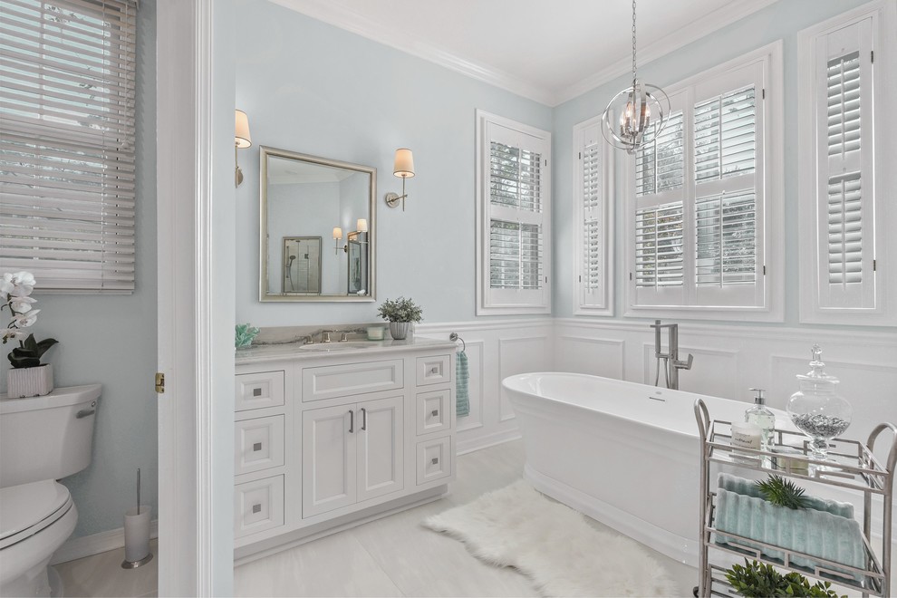 Inspiration for a large transitional master bathroom in Jacksonville with beaded inset cabinets, white cabinets and a freestanding tub.