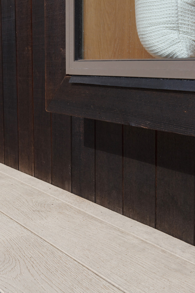 Design ideas for a large contemporary two-storey brown house exterior in Melbourne with wood siding, a flat roof and a metal roof.