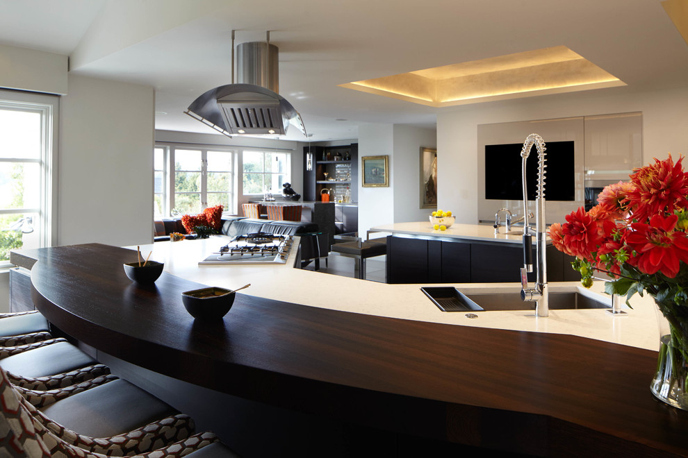 Eat-in kitchen - large transitional gray floor and ceramic tile eat-in kitchen idea in Seattle with quartzite countertops, stainless steel appliances, two islands, an undermount sink, flat-panel cabinets, dark wood cabinets and white countertops