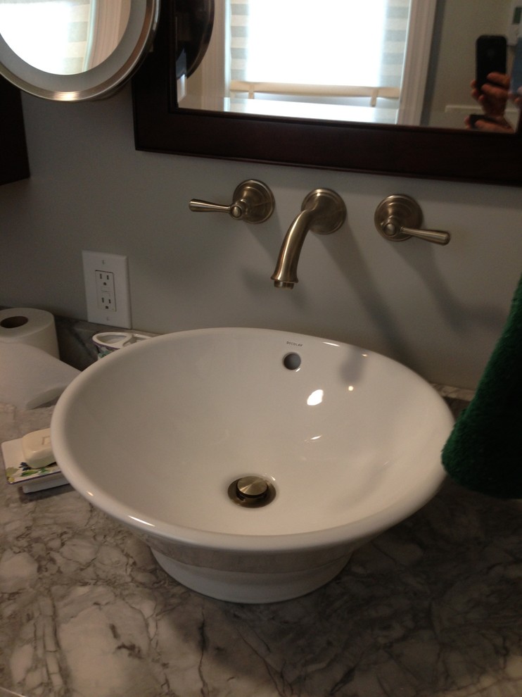 Doorless shower - small transitional 3/4 gray tile, white tile and porcelain tile porcelain tile doorless shower idea in Baltimore with raised-panel cabinets, dark wood cabinets, a two-piece toilet, white walls, a vessel sink and quartzite countertops
