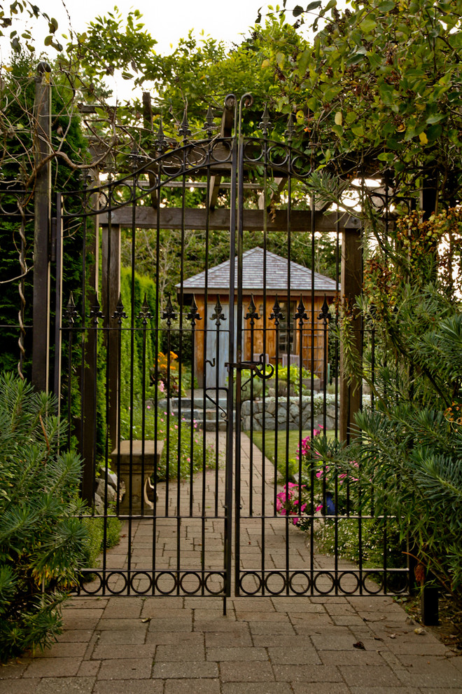 Design ideas for a mid-sized eclectic detached garden shed in Vancouver.