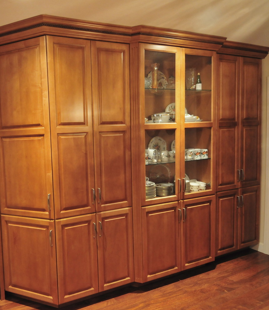 Example of a transitional medium tone wood floor eat-in kitchen design in New York with raised-panel cabinets, medium tone wood cabinets, solid surface countertops, ceramic backsplash, white appliances, no island, an undermount sink and beige backsplash