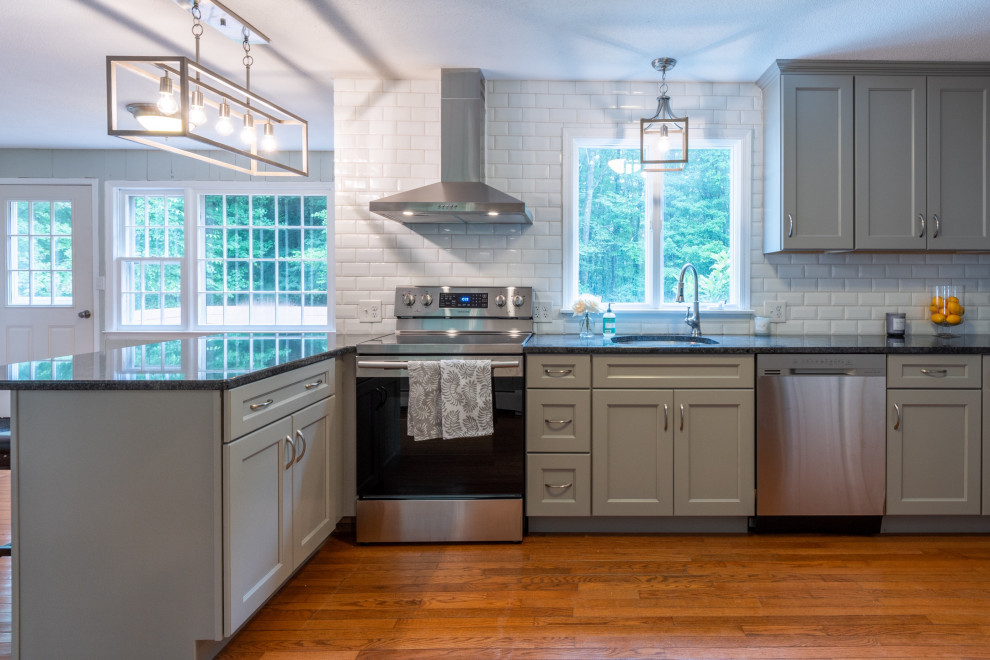 Kitchen - transitional l-shaped kitchen idea in Boston with gray cabinets, granite countertops, white backsplash, ceramic backsplash, an island and gray countertops
