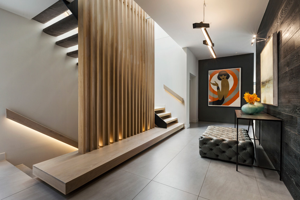 This is an example of a contemporary hallway in Melbourne with black walls and grey floor.