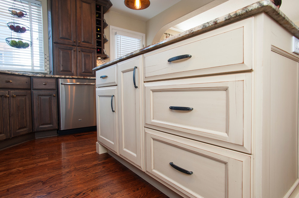 Mountain style kitchen photo in Denver with flat-panel cabinets and distressed cabinets