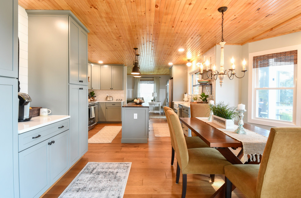 Design ideas for a large transitional u-shaped eat-in kitchen in DC Metro with a farmhouse sink, recessed-panel cabinets, turquoise cabinets, quartz benchtops, white splashback, subway tile splashback, stainless steel appliances and with island.