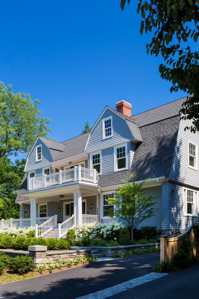 Photo of a large traditional three-storey grey exterior in Boston with wood siding, a gambrel roof and a shingle roof.