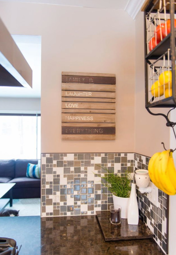 Inspiration for a mid-sized transitional galley medium tone wood floor and brown floor eat-in kitchen remodel with an undermount sink, shaker cabinets, white cabinets, marble countertops, metallic backsplash, mosaic tile backsplash, stainless steel appliances and a peninsula