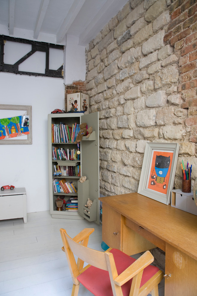 Photo of an industrial kids' room in Paris with white walls and painted wood floors.