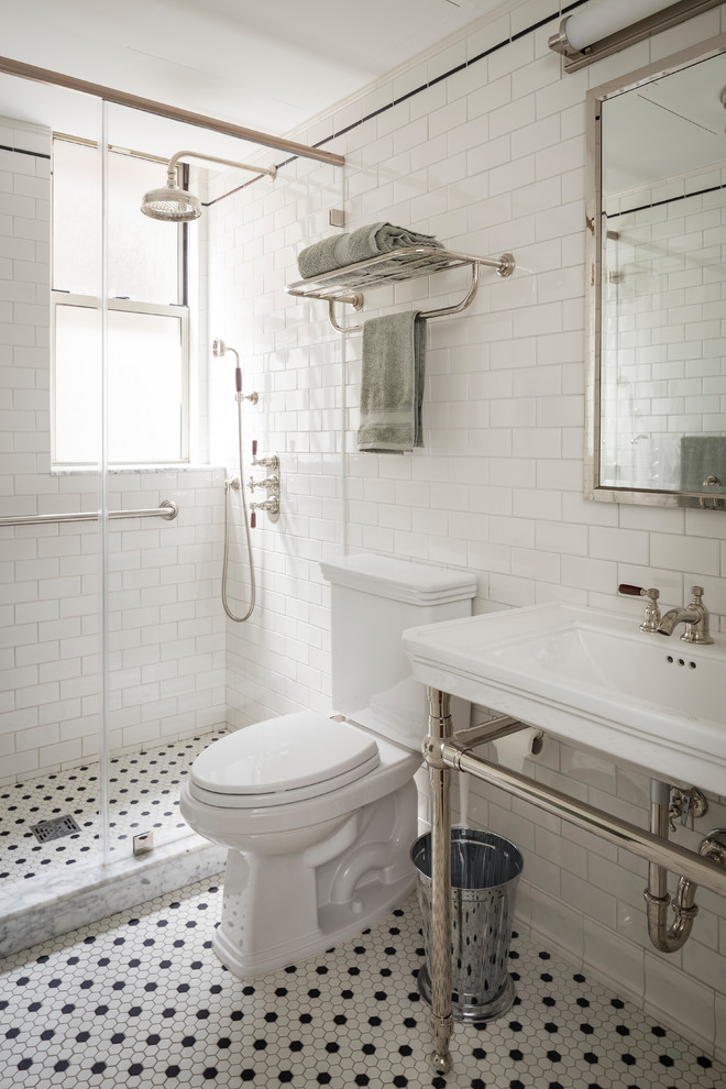 Traditional 3/4 bathroom in New York with a corner shower, white tile, subway tile, white walls, mosaic tile floors, a wall-mount sink, white floor and a hinged shower door.