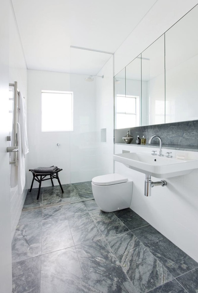 Photo of a contemporary bathroom in Sydney with a wall-mount sink, a curbless shower, white tile and white walls.