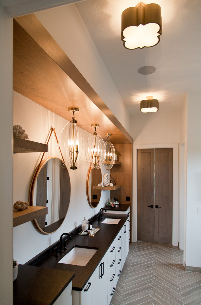 Inspiration for a large contemporary master bathroom in Kansas City with flat-panel cabinets, white cabinets, a freestanding tub, a corner shower, white walls, ceramic floors, an undermount sink, granite benchtops, beige floor, a hinged shower door and black benchtops.