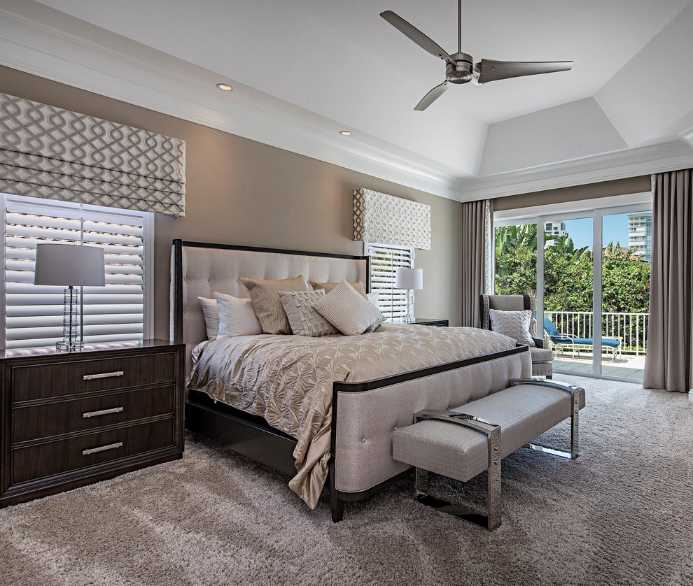 Photo of a contemporary master bedroom in Miami with beige walls and carpet.