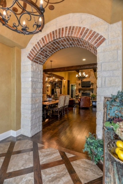 Photo of a mid-sized mediterranean foyer in Other with yellow walls, a single front door, a metal front door and concrete floors.
