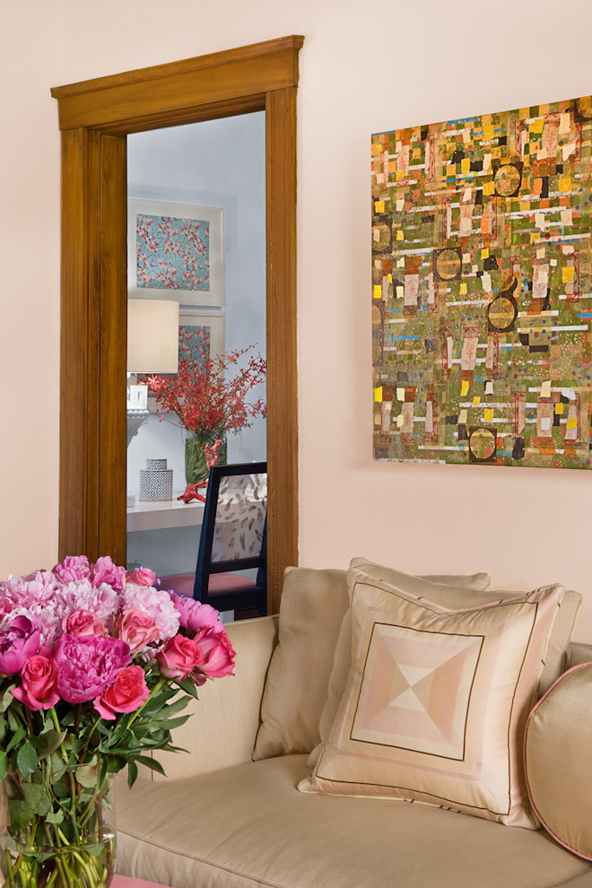 Inspiration for a traditional living room in Boston with pink walls.