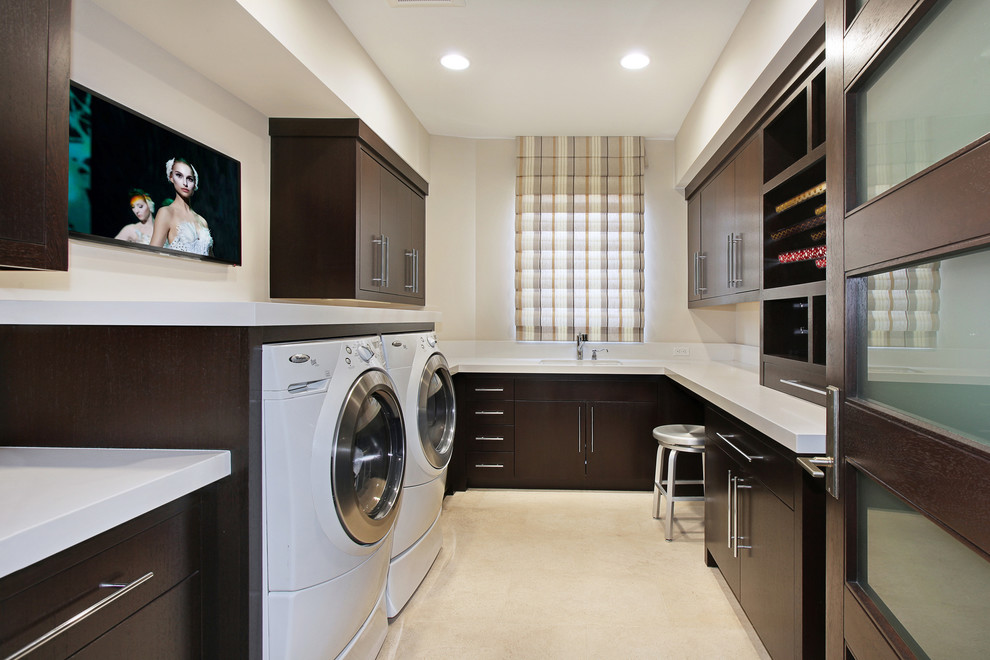 Design ideas for a transitional laundry room in Orange County with dark wood cabinets and white benchtop.