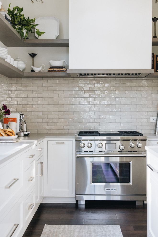 Open concept kitchen - large transitional u-shaped dark wood floor, brown floor and exposed beam open concept kitchen idea in Chicago with a drop-in sink, shaker cabinets, medium tone wood cabinets, multicolored backsplash, paneled appliances, two islands and multicolored countertops