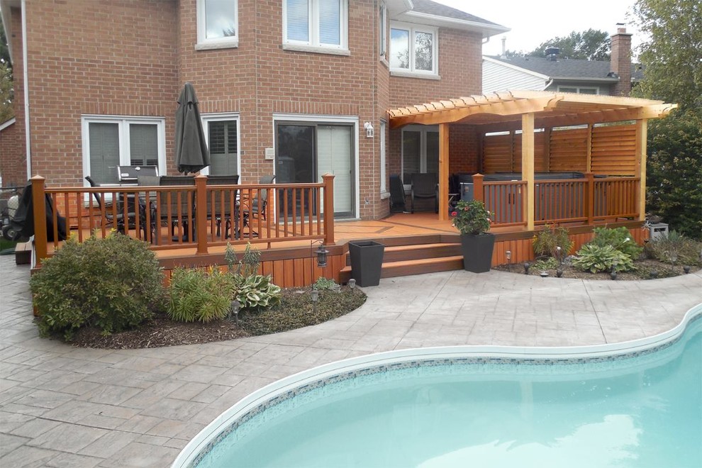 Design ideas for a large arts and crafts backyard deck in Toronto with a pergola.