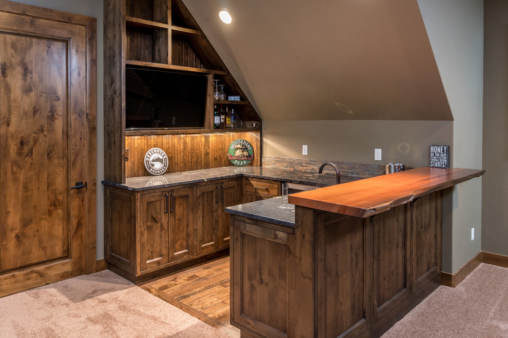Design ideas for a mid-sized country u-shaped wet bar in Other with an undermount sink, beaded inset cabinets, medium wood cabinets, wood benchtops, multi-coloured splashback, stone tile splashback and medium hardwood floors.