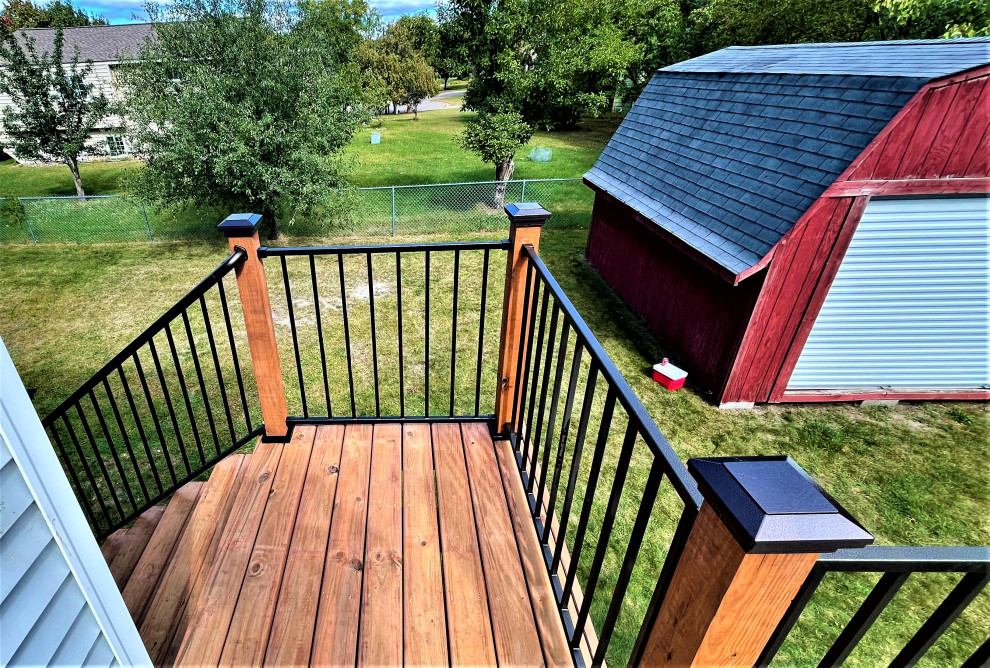 Photo of a medium sized rustic back first floor metal railing terrace in Minneapolis with no cover.