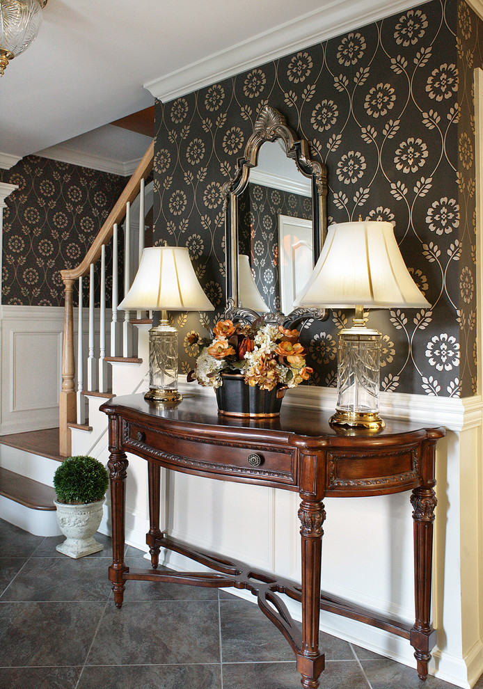 Inspiration for a traditional foyer in New York with multi-coloured walls and grey floor.
