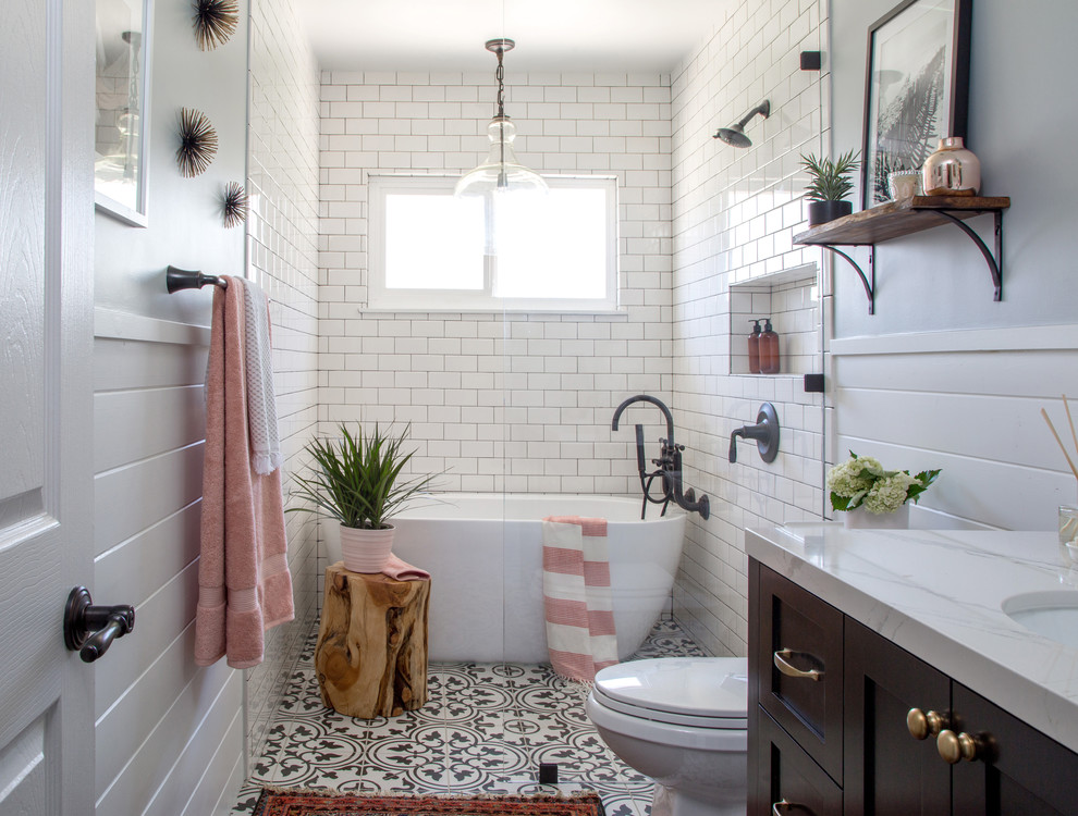 Inspiration for a mid-sized country bathroom in Los Angeles with shaker cabinets, a freestanding tub, white tile, subway tile, an undermount sink, brown cabinets, a curbless shower, a two-piece toilet, grey walls, cement tiles, marble benchtops, black floor and an open shower.