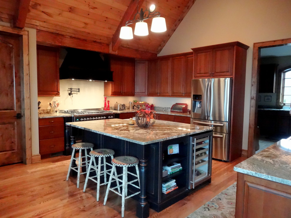 Inspiration for a large rustic u-shaped light wood floor eat-in kitchen remodel in Charlotte with a farmhouse sink, raised-panel cabinets, dark wood cabinets, granite countertops, beige backsplash, stainless steel appliances and an island