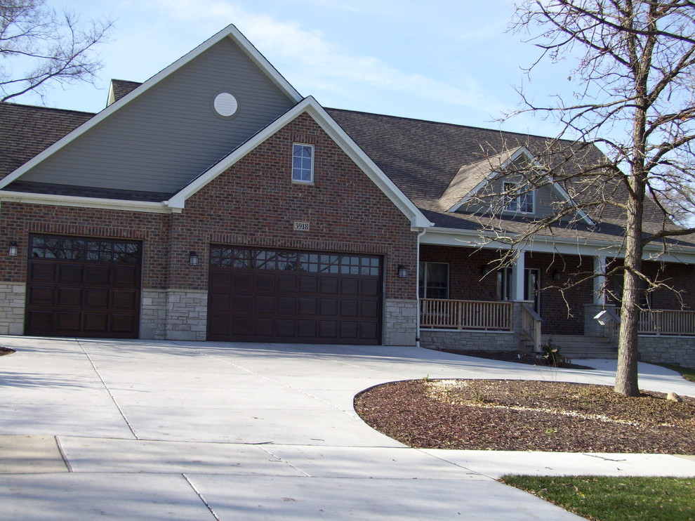 This is an example of a mid-sized contemporary two-storey brick grey exterior in Chicago.