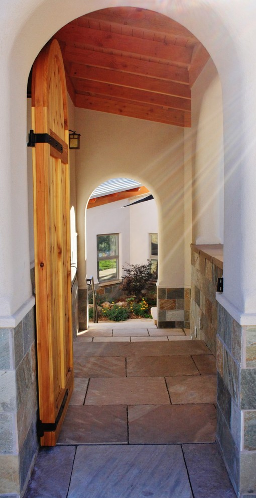 Example of a transitional home design design in Denver