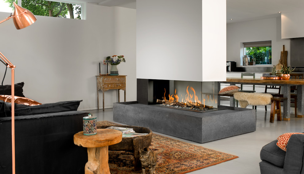 This is an example of a large contemporary formal living room in Toronto with a two-sided fireplace, beige walls, concrete floors and grey floor.