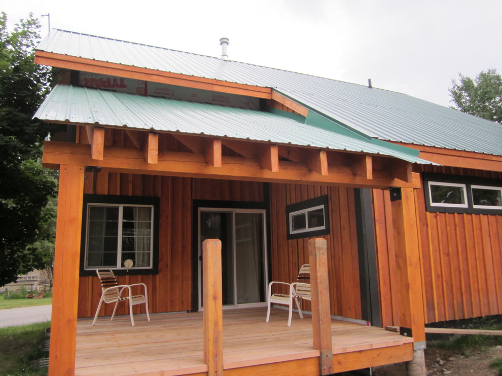 Inspiration for a mid-sized rustic side yard balcony deck remodel in Vancouver with a roof extension