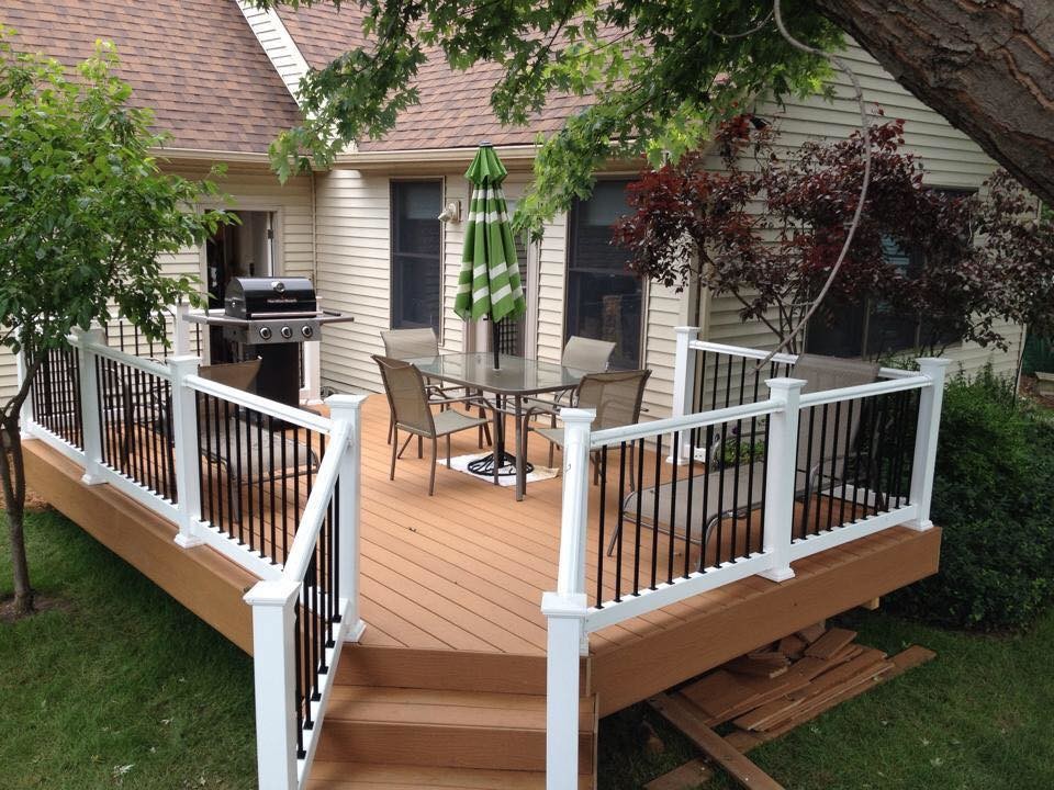 Example of a mid-sized backyard deck design with no cover