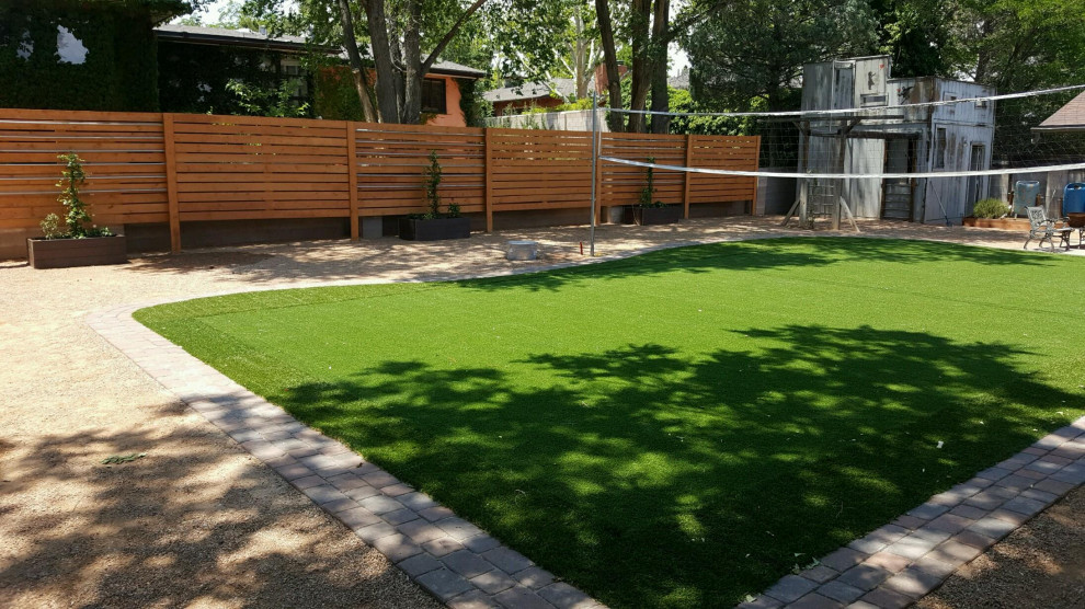Photo of a mid-sized backyard full sun outdoor sport court in Albuquerque with gravel.