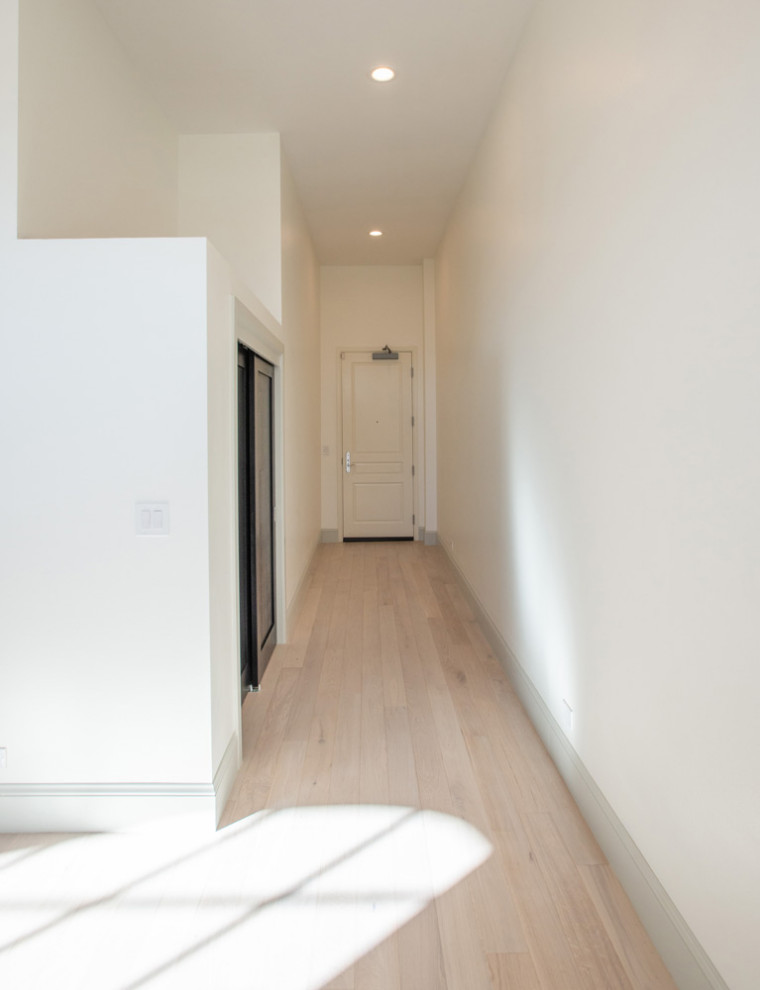 Hallway - mid-sized contemporary medium tone wood floor hallway idea in Santa Barbara with beige walls