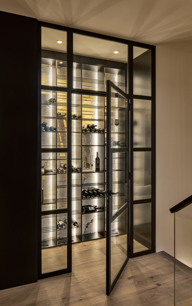 Design ideas for a mid-sized contemporary wine cellar in Sydney with light hardwood floors, display racks and beige floor.