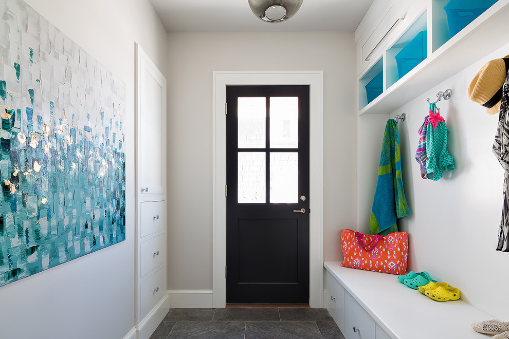 Design ideas for a transitional mudroom in New York with a single front door, a black front door and white walls.