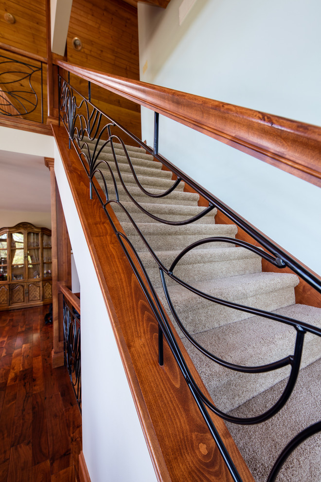 This is an example of a mid-sized traditional carpeted straight staircase in Chicago with carpet risers and mixed railing.
