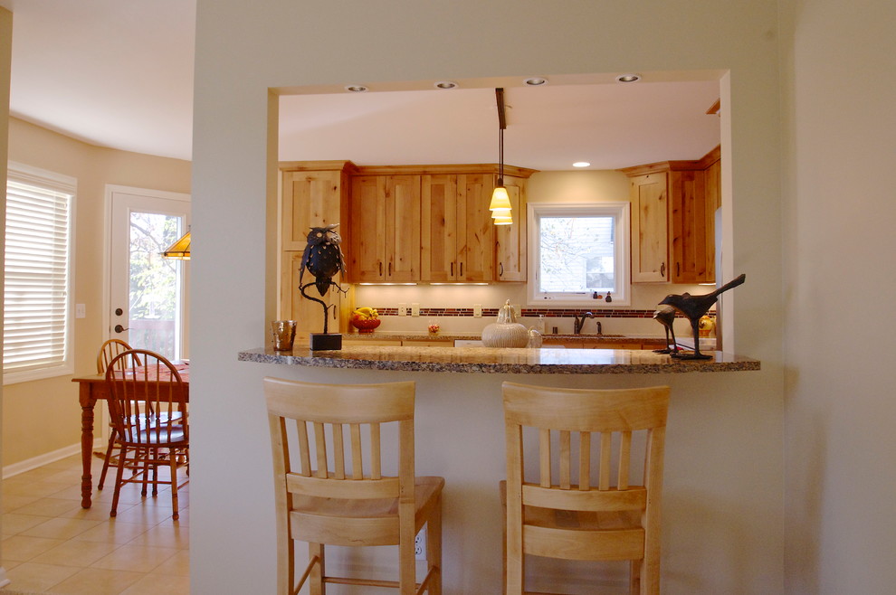 Inspiration for a transitional l-shaped porcelain tile eat-in kitchen remodel with an undermount sink, flat-panel cabinets, light wood cabinets, quartz countertops, beige backsplash, ceramic backsplash, white appliances and an island