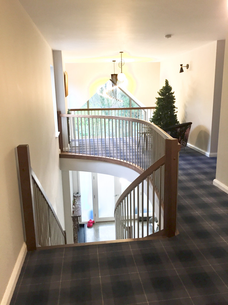 Photo of a mid-sized contemporary wood curved staircase in Other.